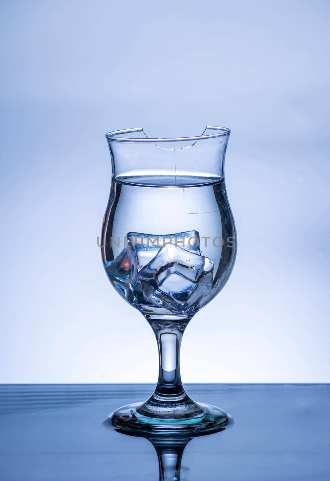 The image of pouring drinking water, into a broken glass, that makes one feel refreshed on blurred white background, Splashing water, Sparkling water, Danger or imminent danger concept
