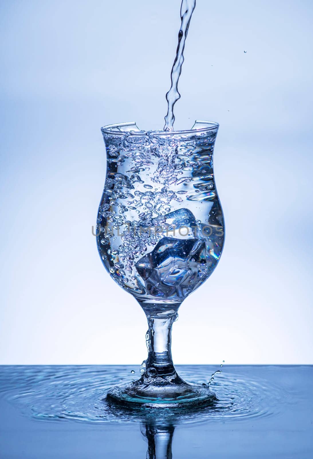 The image of pouring drinking water, into a broken glass, that makes one feel refreshed on blurred white background, Splashing water, Sparkling water, Danger or imminent danger concept