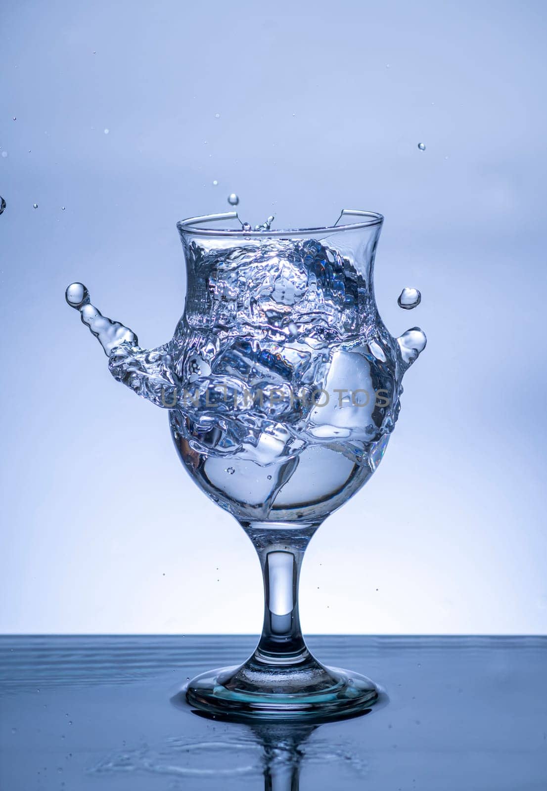 The image of pouring drinking water, into a broken glass, that makes one feel refreshed on blurred white background, Splashing water, Sparkling water, Danger or imminent danger concept