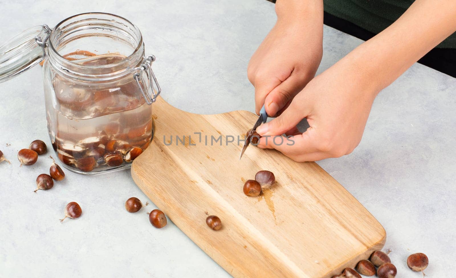 Preparing chestnut liquid soap, cutting buckeye and putting it into a jar with water, alternative homemade detergent for washing clothes