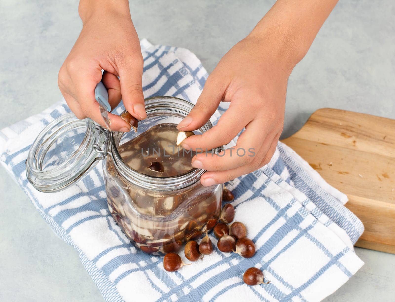 Preparing chestnut liquid soap, cutting buckeye and putting it into a jar with water, alternative homemade detergent for washing clothes