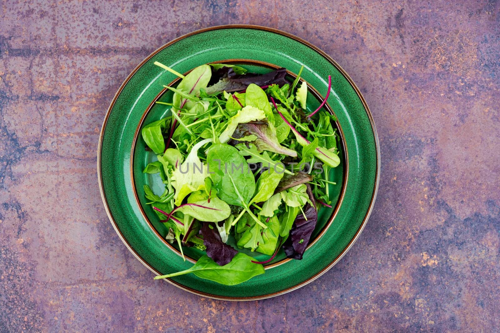 Green fresh salad with arugula, spinach, purple lettuce and chard. Fresh spring salad.