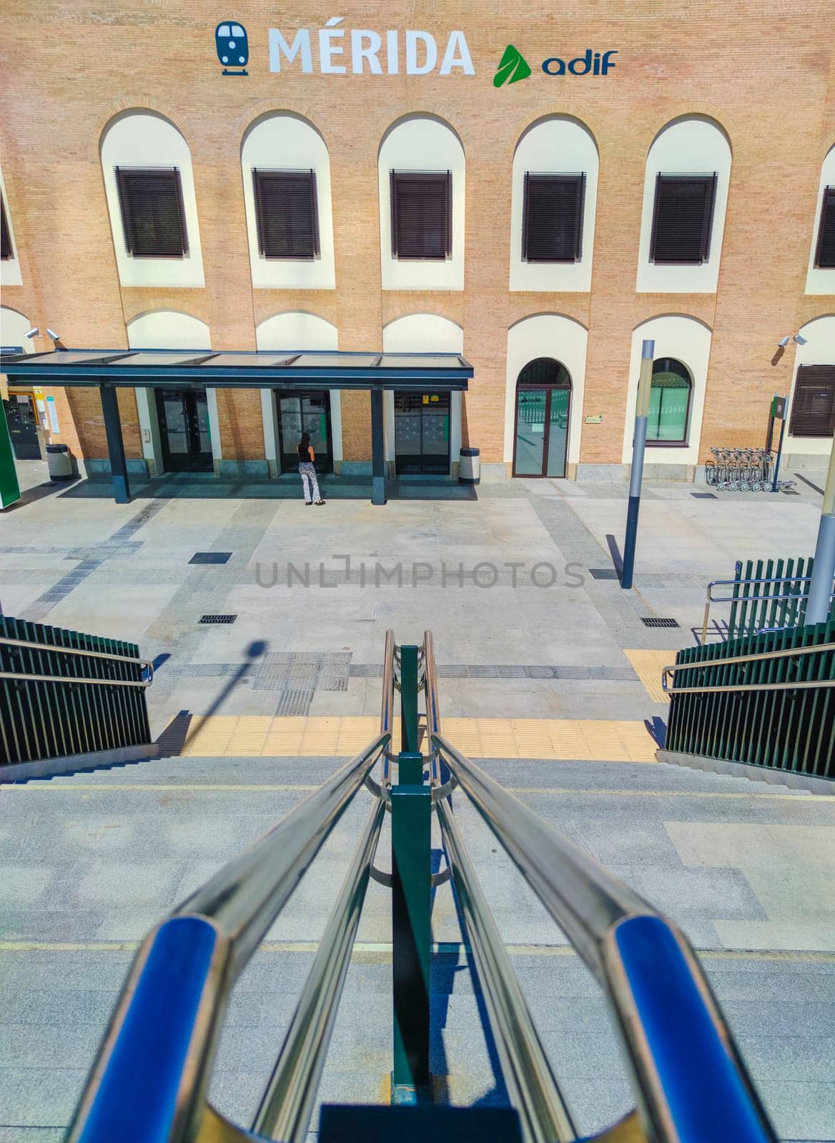 Merida, Spain - Setp 18th, 2021: Merida train station stairs access. Chrome handrails