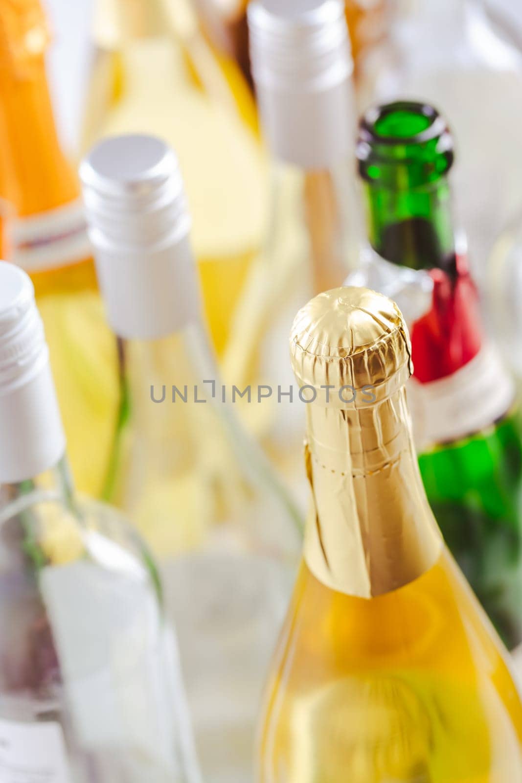 Full and empty bottles of different alcoholic drinks, abuse and alcohol addiction. Alcoholism concept.
