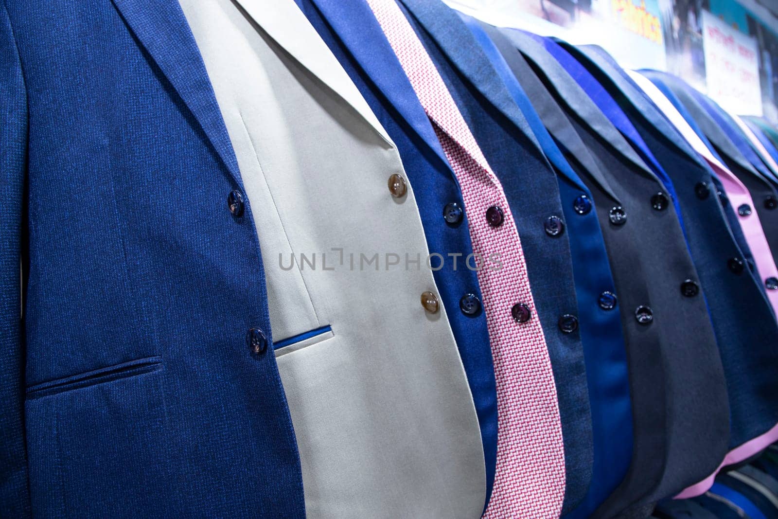 Men's clothing on hangers in a shop, closeup of photo