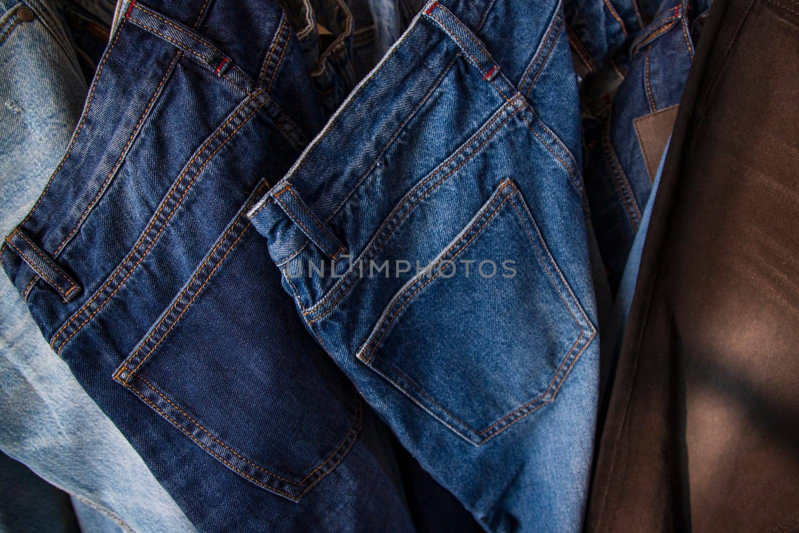 Jeans hanging on a rack in a store, close-up