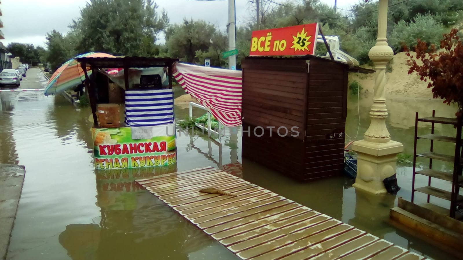 Anapa, Russia August 13 2021 Flooding caused by heavy rains and downpours. Consequences of a typhoon, cyclone or hurricane. Shopping street flooded with dirty water. Wet belongings and beach walkways