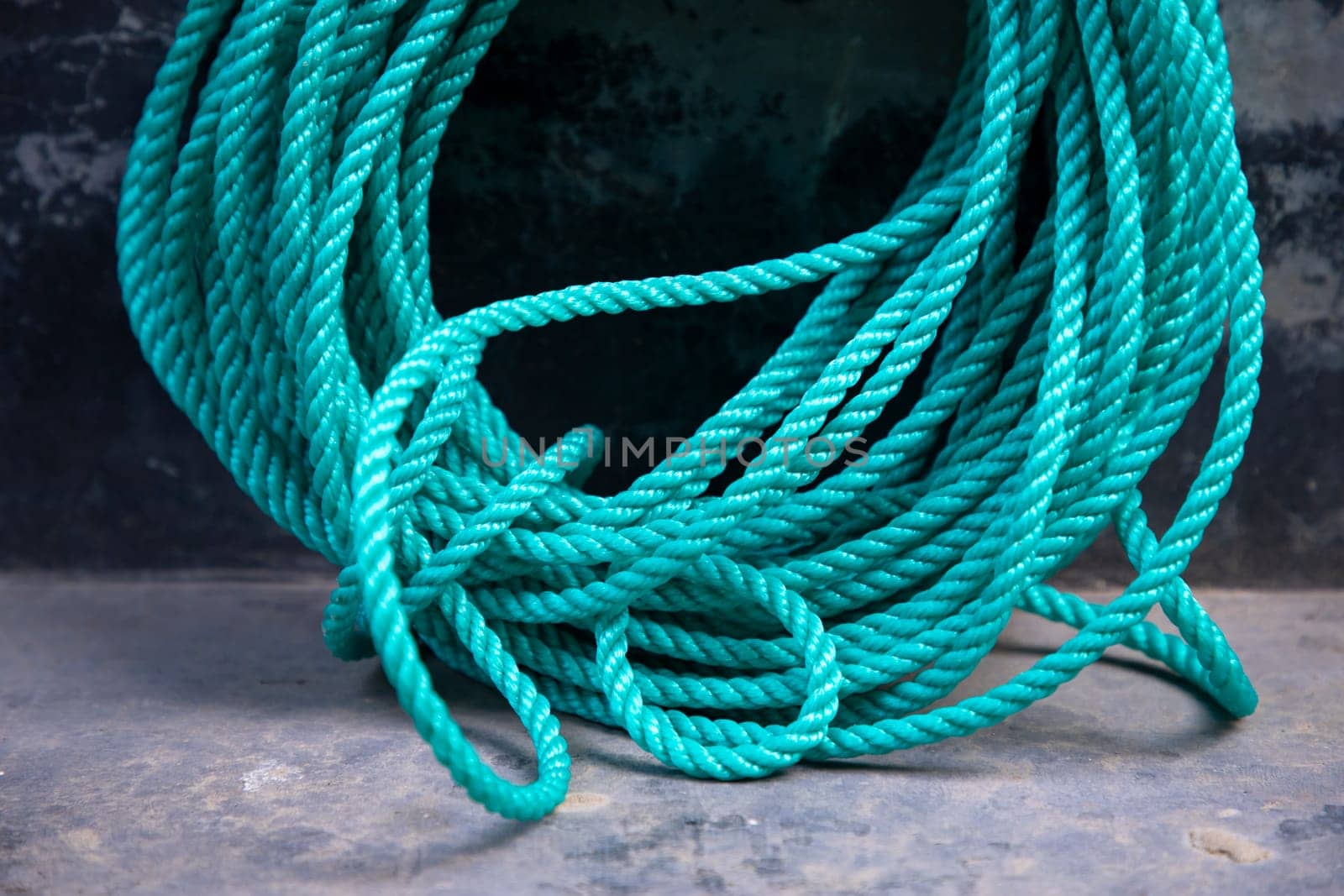 green rope tied up on the dock of the ship, stock photo