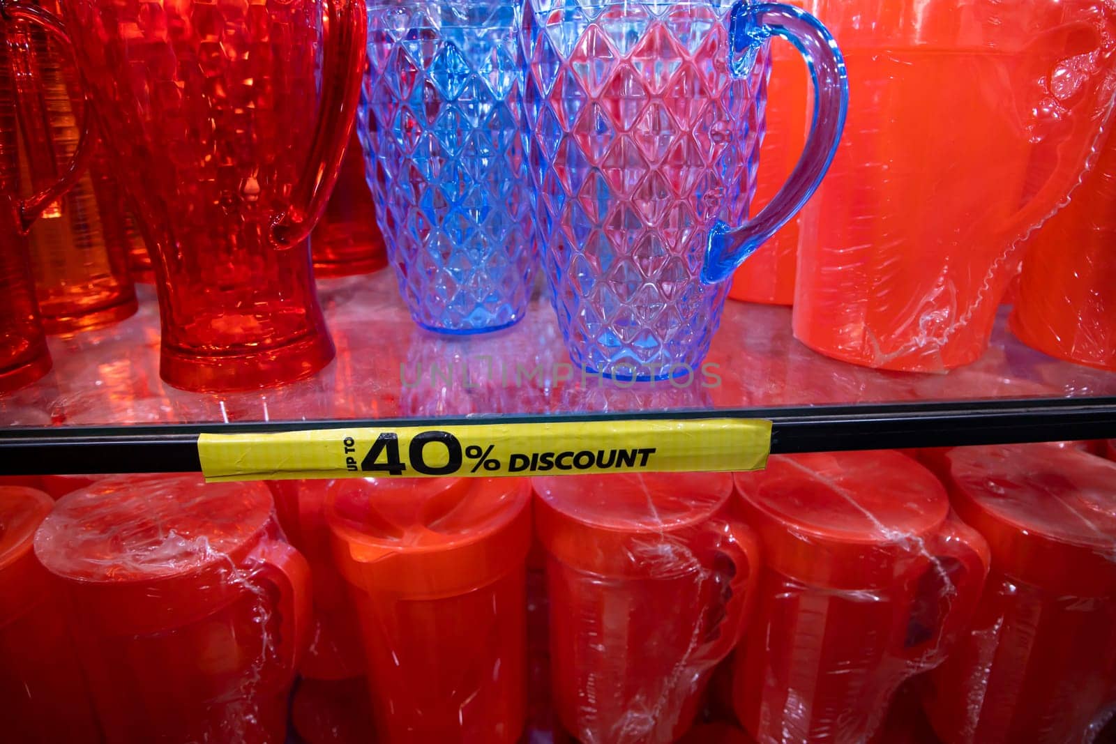 Colorful Plastic jug on a shelf in a supermarket, closeup of photo