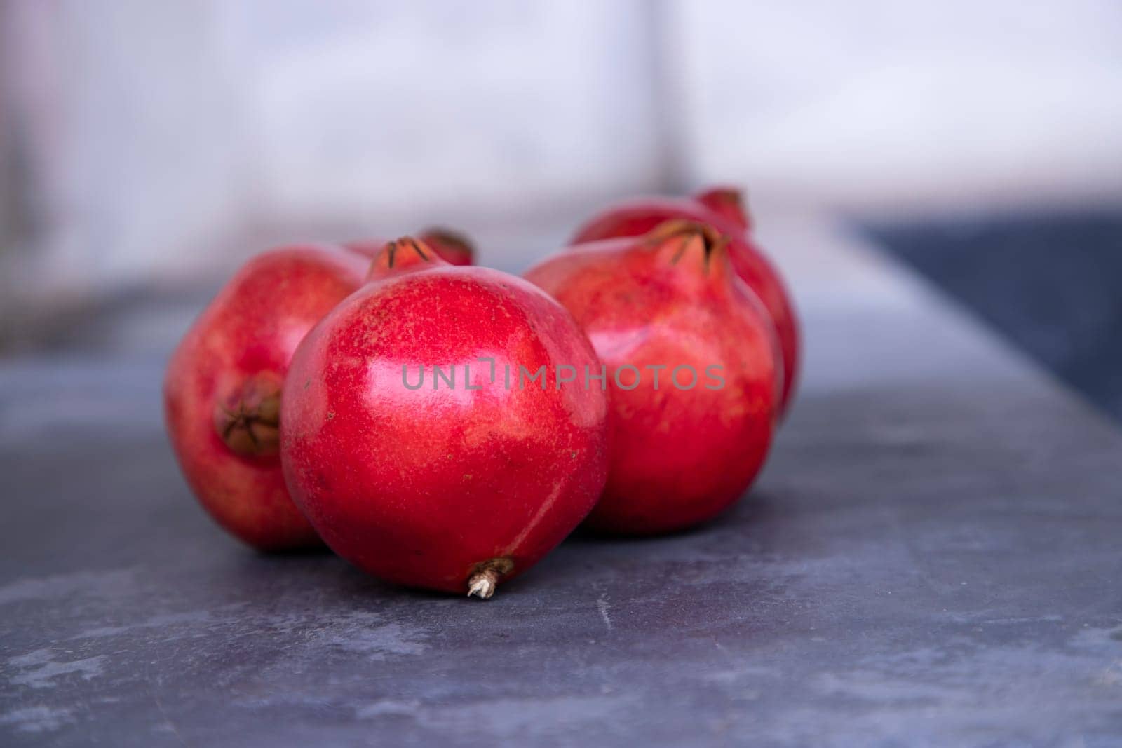 Ripe pomegranates on a gray background. Selective focus