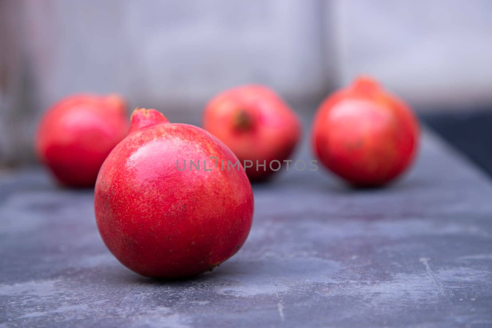 Ripe pomegranates on a slate board. Selective focus