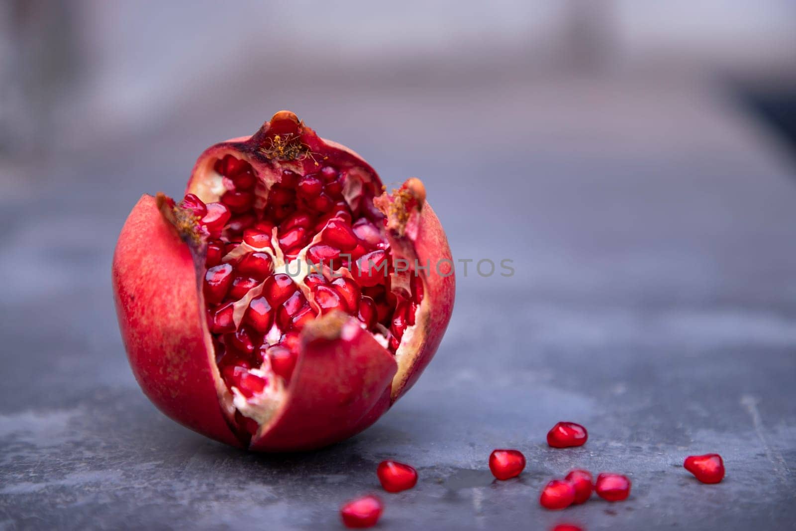 Pomegranate fruit on a dark background. Selective focus.