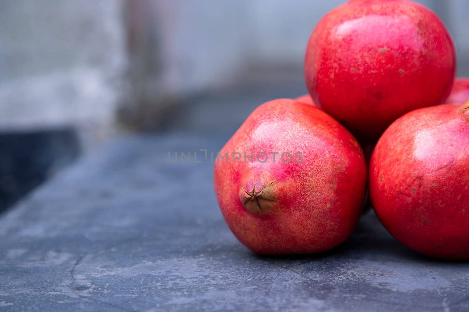 Ripe pomegranates on a dark background. Selective focus