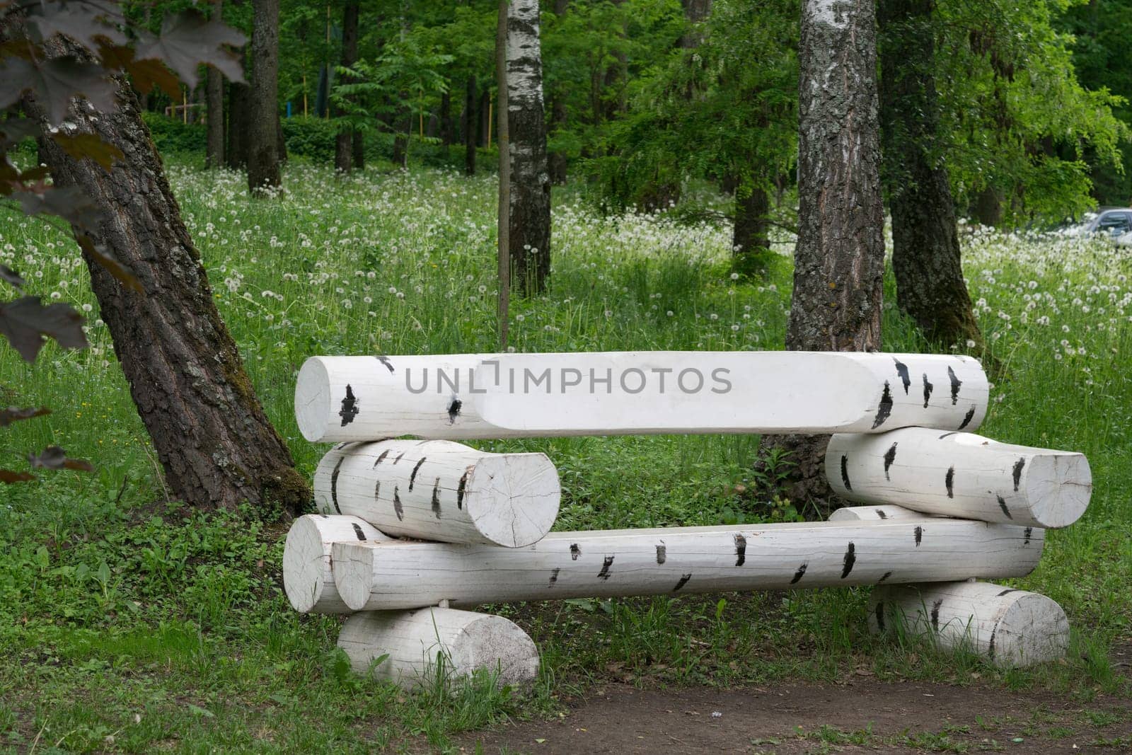 Bench made of wooden logs, similar to birch