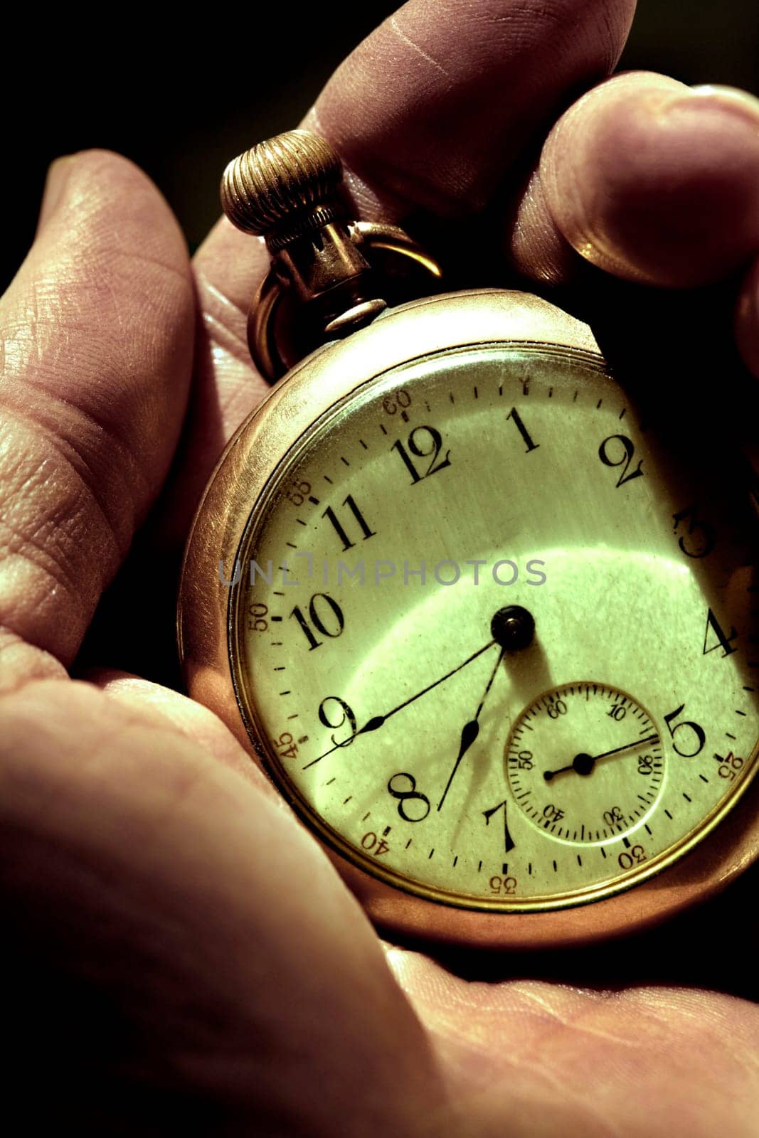 Man looking at his pocket Watch.