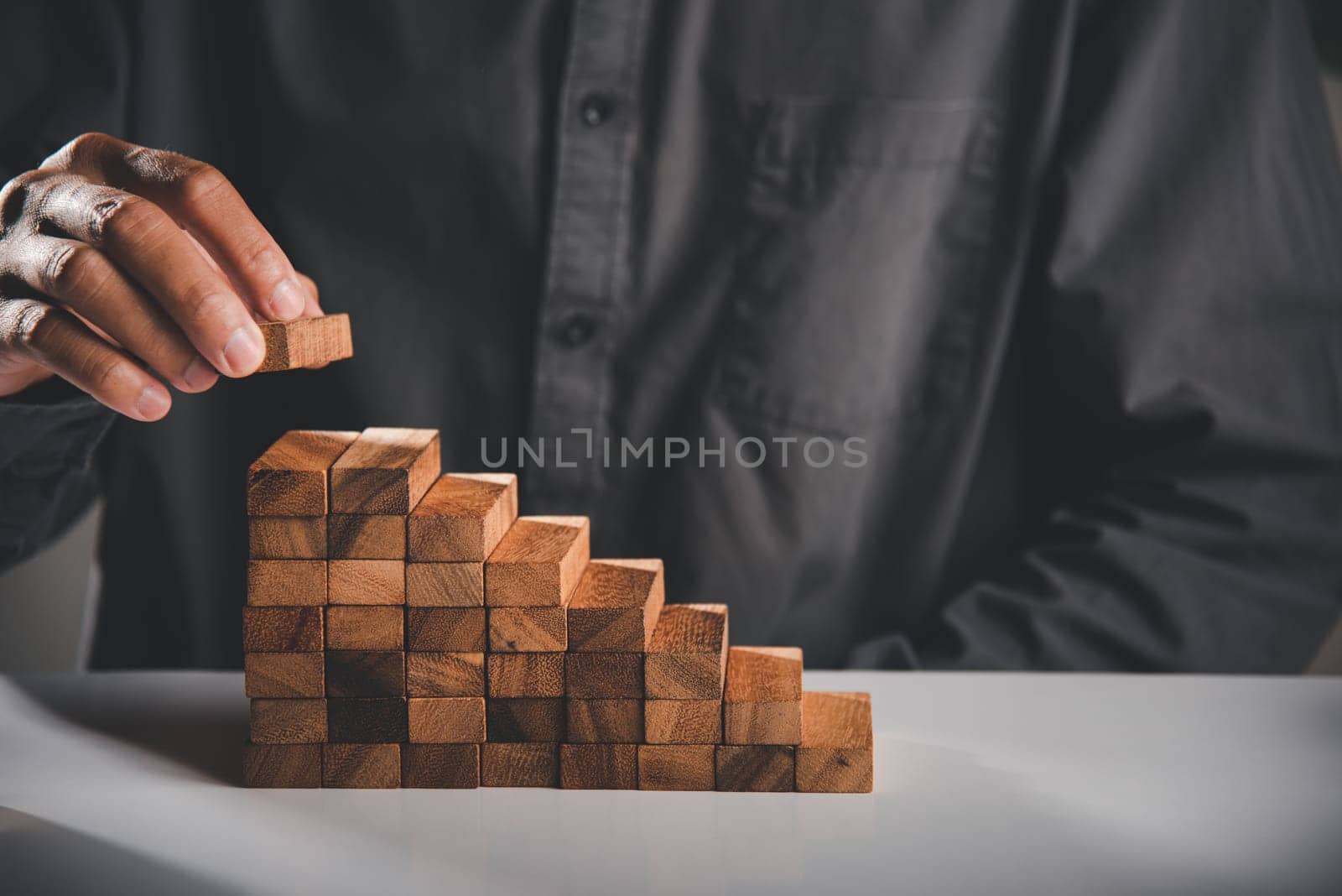 Business hand arranging put wooden block stacking step stair growth success process, financial risk management and strategic plan and business challenge planning concept, prevent collapse or crash