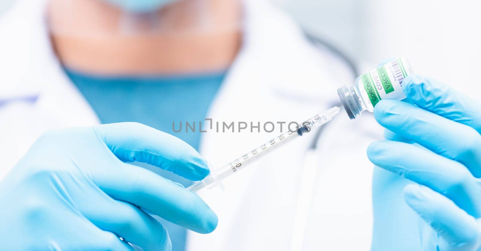 COVID-19 vaccine, Doctor man pull syringe on liquid bottle COVID-19 (coronavirus) vaccine for injection at hospital, nurse holding medicine and drug concept