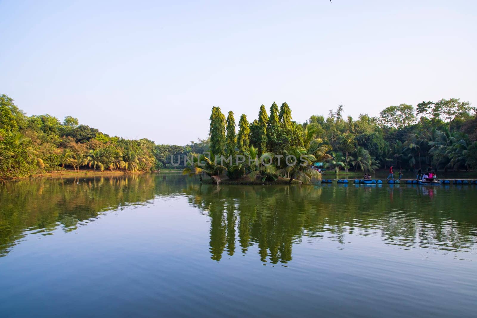 Natural landscape view Reflection of trees in the lake water against blue sky