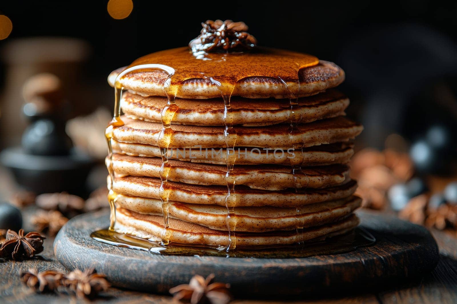 A delightful stack of fluffy pancakes towers high, dripping with syrup and accented by fragrant star anise, surrounded by spices.