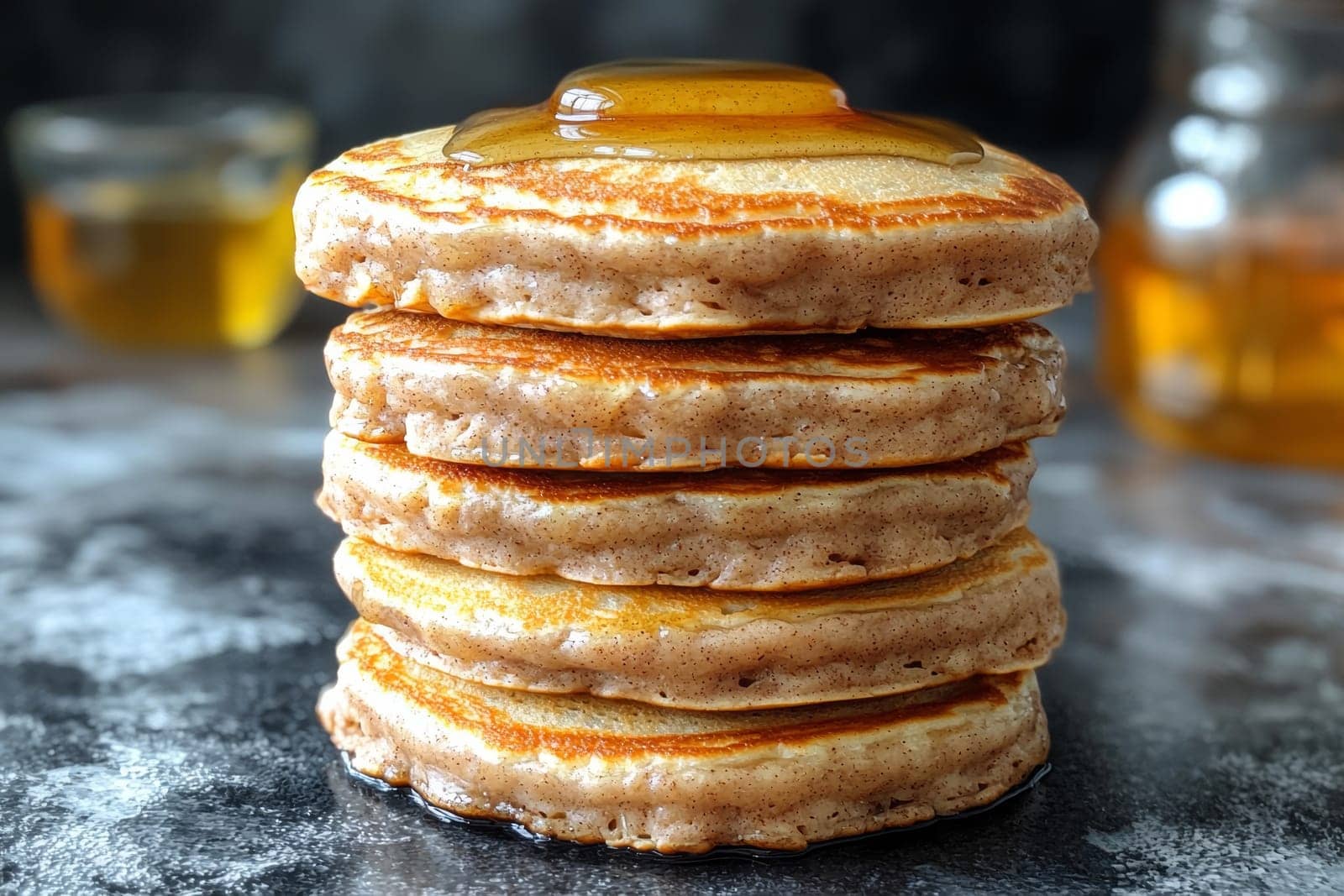 Fluffy pancakes piled high with a glossy drizzle of syrup, creating a warm and inviting breakfast setting in a cozy kitchen.