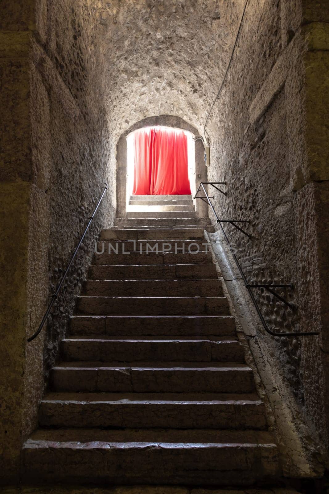 Old corridor with red curtain at the end. Concept for mystery, gothic, escape, hope