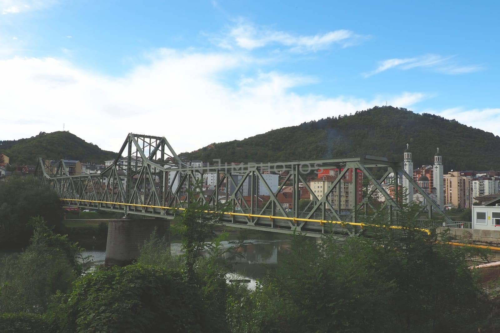 Zvornik, Bosnia and Herzegovina, Mali Zvornik, Serbia, September 29 2022 Drina river. Metal bridge across the Drina. Border point. View of coasts Serbia and BiH. Residential houses and Orthodox Church