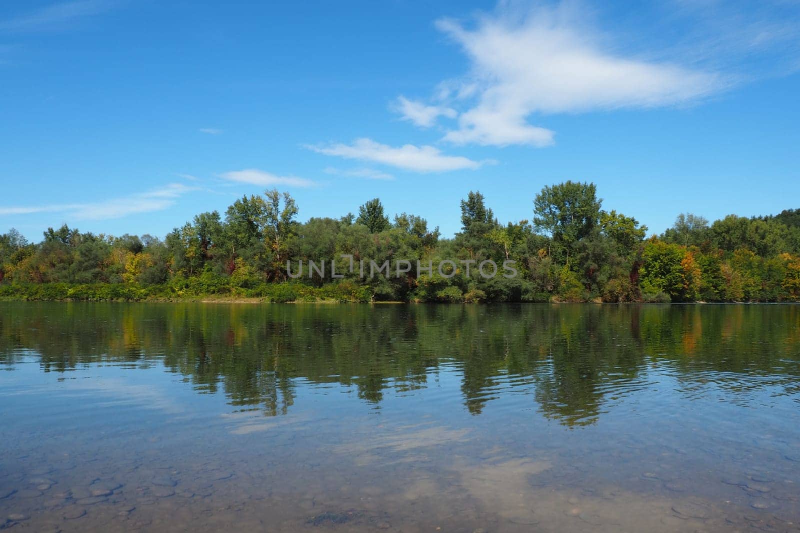 Drina river near the town of Banja Koviljaca, Serbia, view of the coast of Bosnia and Herzegovina. Rybnik on the Drina. The flow of water, blue sky, greenery on the opposite side of the river