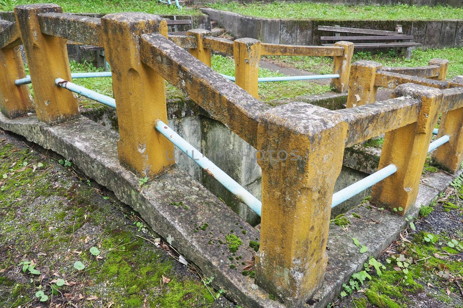 Banja Koviljaca, Loznica, Serbia. Mount Guchevo, park and forest. Source of mineral sulfuric and ferruginous water Rakina Chesma Cesma. A spring near the road to Guchevo. Concrete fence and stairs