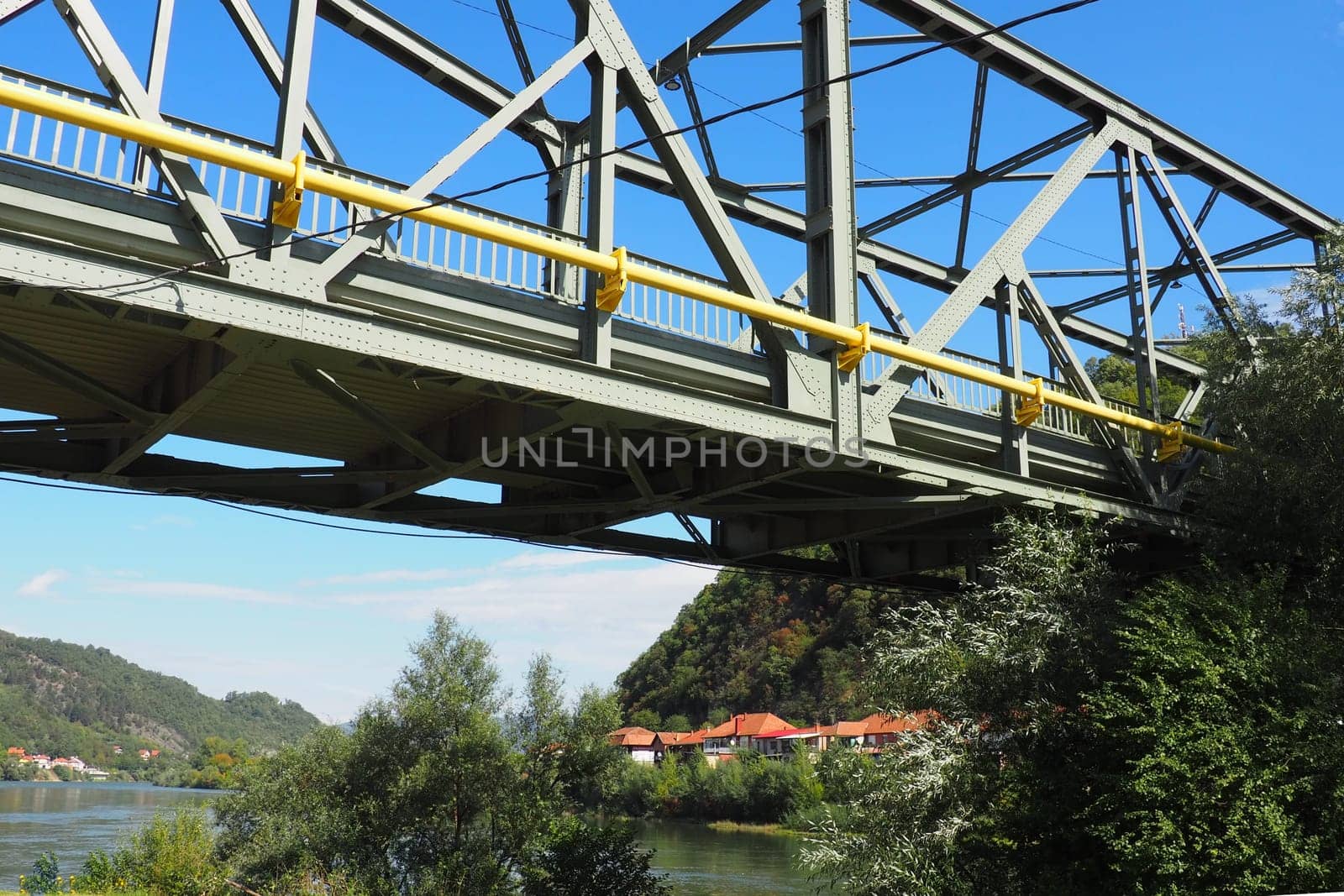 Zvornik, Bosnia and Herzegovina, Mali Zvornik, Serbia, September 29 2022 Drina river. Metal bridge across the Drina. Border point. View of coasts Serbia and BiH. The flow of water, residential houses
