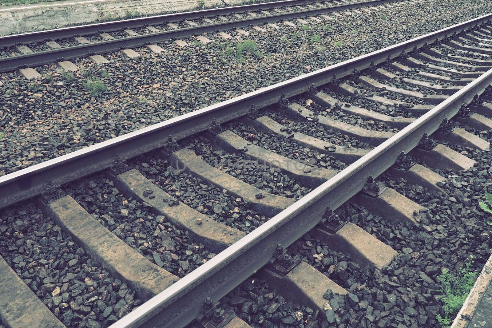 Railways. Metal steel rails and wooden sleepers. Rivets and fasteners on the railroad. Stony backfill of railway tracks. Station Nyrki, Karelia