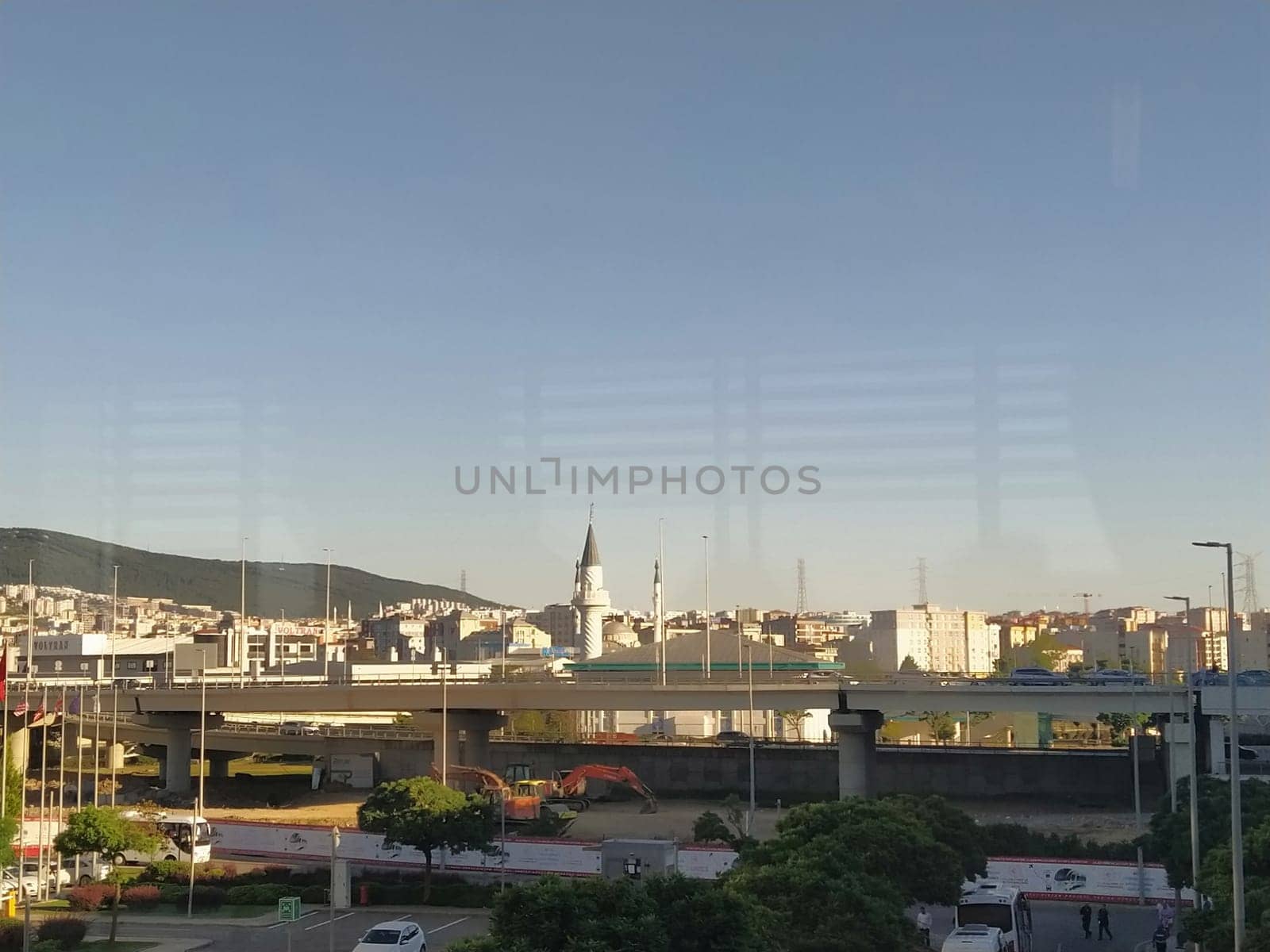 Istanbul Turkey, Sabiha Gokcen Airport Uluslararasi Havalimani 04.08.2022 view from window on Istanbul through the glass. Earthquake resistant high-rise buildings, new roads, transport and a mosque