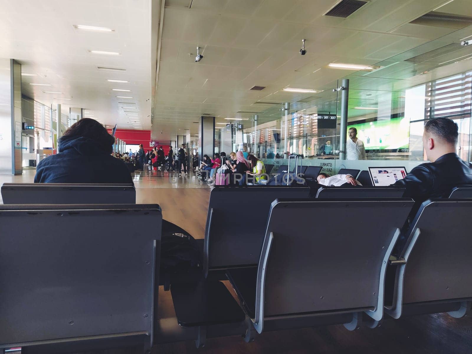 Istanbul Turkey, Sabiha Gokcen Airport Uluslararasi Havalimani 04.08.2022 The waiting room at the airport for stay of passengers. People passengers waiting to board the flight. Airport interior.