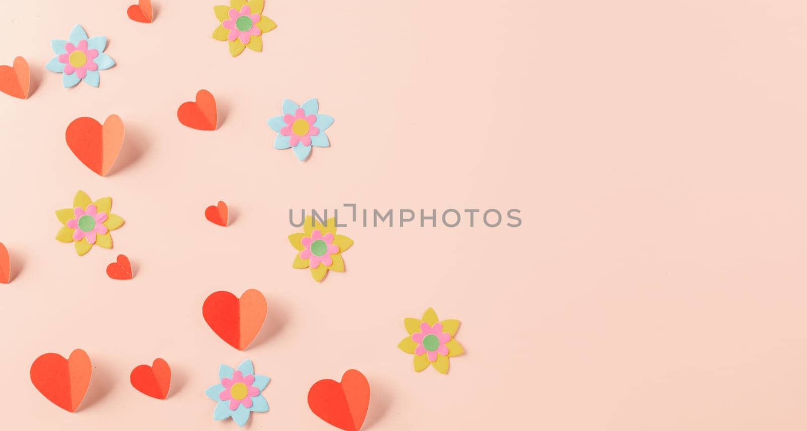 Happy Valentine's day concept. Symbol of love paper art with copy space for text, handmade red paper hearts shape cutting pastel pink background, Mother's Day
