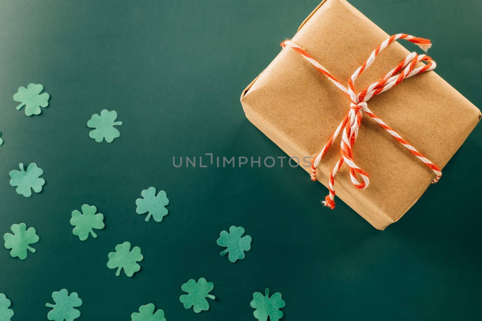Happy St Patricks Day decoration background. above view gift box green clover leaves festive decor, shamrocks leaves holiday symbol with copy space on green background, Banner greeting card concept