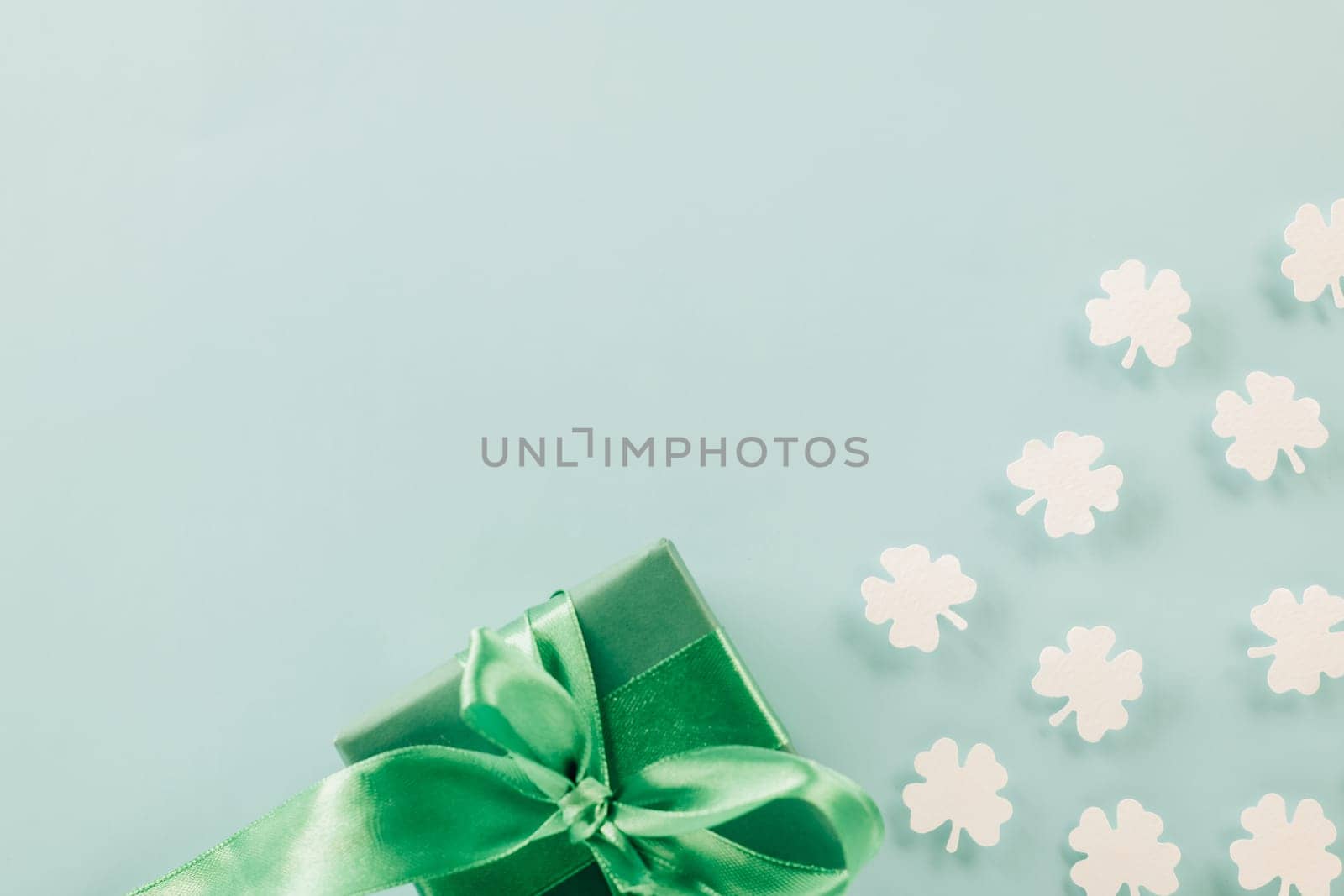 St Patricks Day decoration background concept. shamrocks leaves holiday symbol with copy space on pastel background, above view gift box green clover leaves festive decor, Banner greeting card