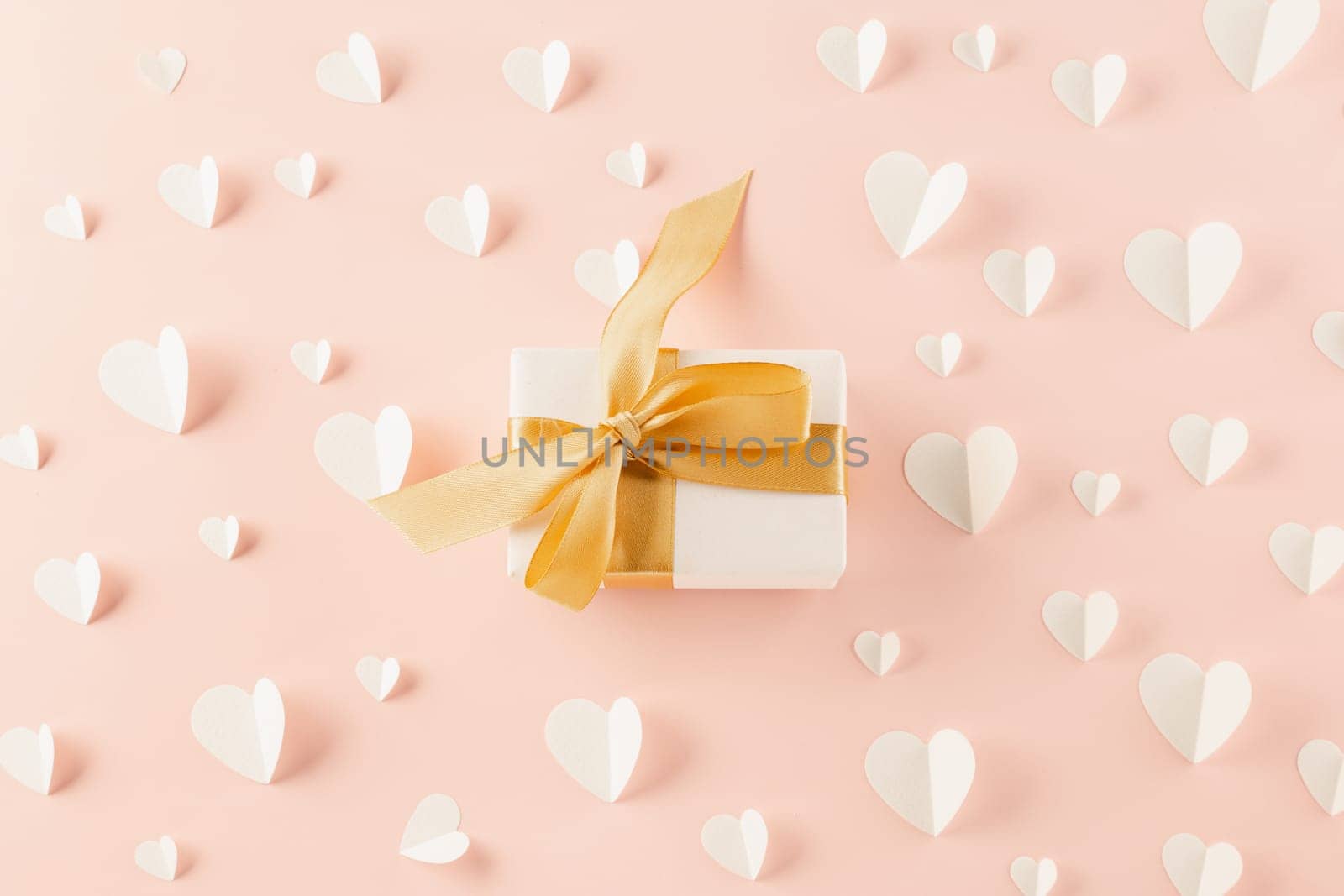 Happy Valentine Day Background. Flat lay beautiful paper hearts and gift box on pastel pink background surprise your loved with copy space, mother's day, concept banner holiday, Valentines day concept