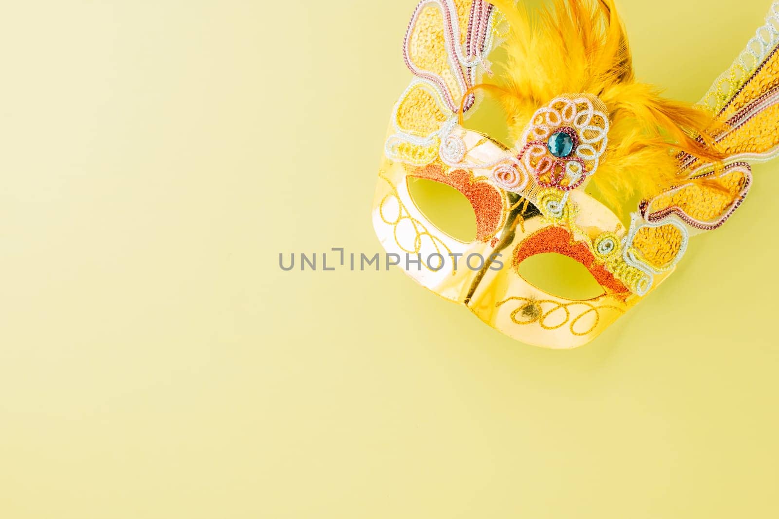 Happy Purim carnival accessories. Top view carnival mask for Mardi Gras celebration isolated on pastel green background, jewish holiday, Purim in Hebrew holiday