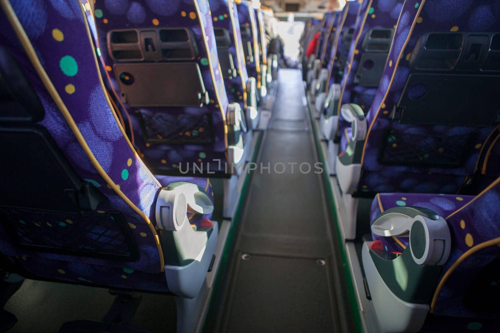 Tourist bus interior. Seats lines seen from back