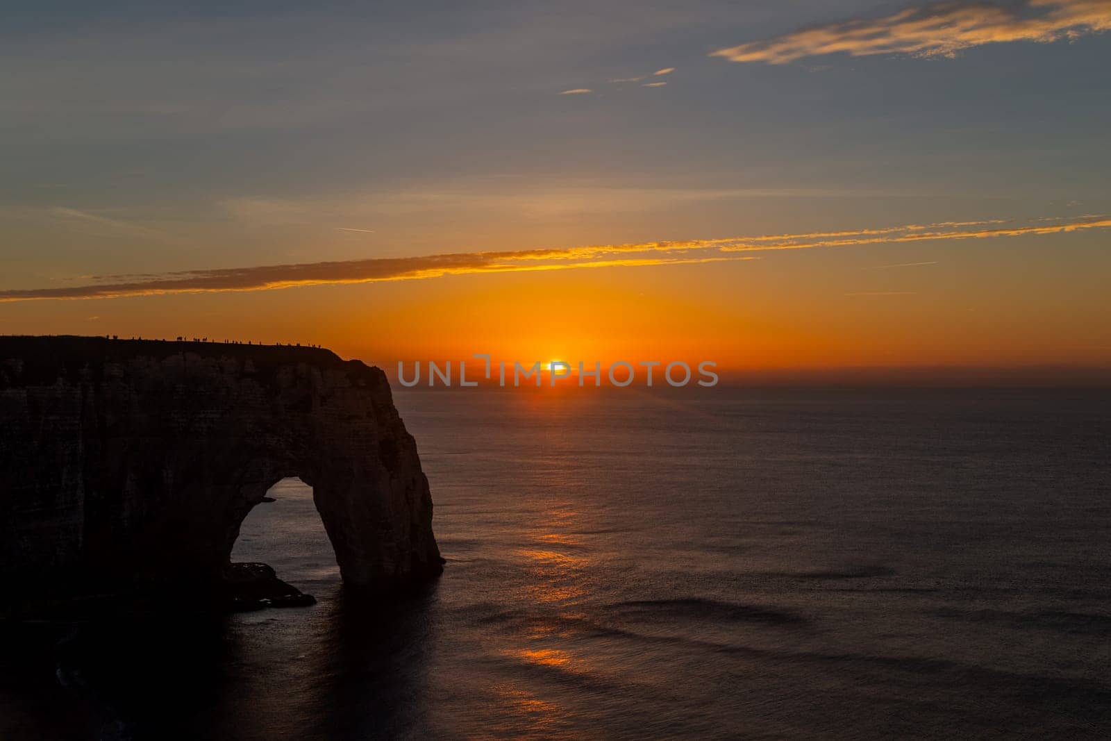Dramatic sunset on the coast in Etretat, France. Etretat is a charming town famous for the stunning cliffs of Etretat on the Alabaster Coast