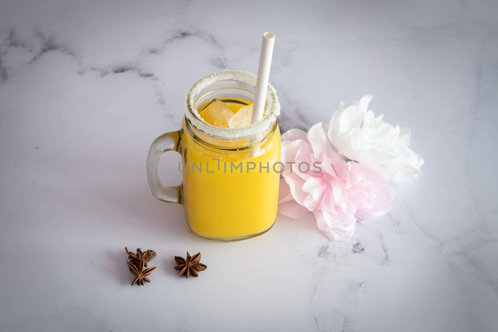 Manga fresh Smootie on a marble table ready to be eat