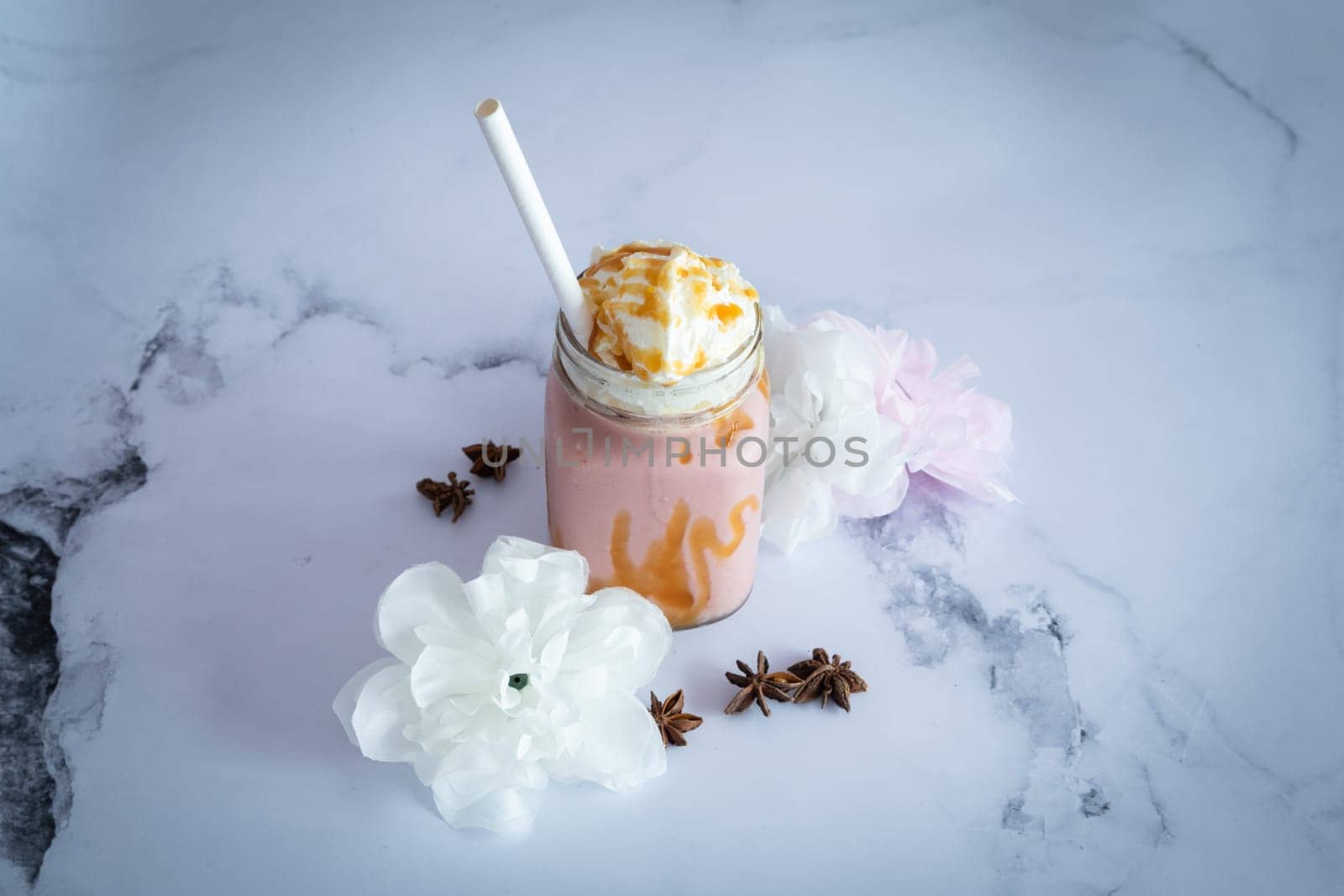 strawberry fresh Smootie on a marble table ready to be eat