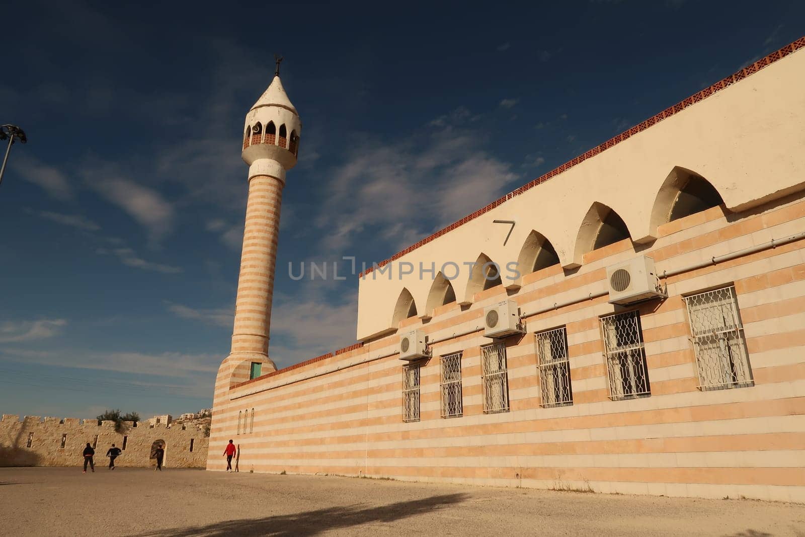 Kids playing in front of Haj Hamdi Mosque Alanis in As-Salt, Salt, Jordan 2021