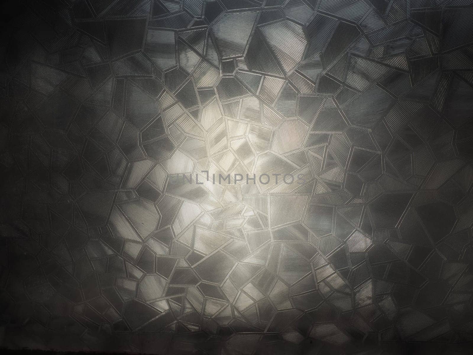 corrugated glass, black and white monochrome image. Abstract pattern on a window or glass surface. Reflection and refraction of light. Protective opaque film glued to the glass.