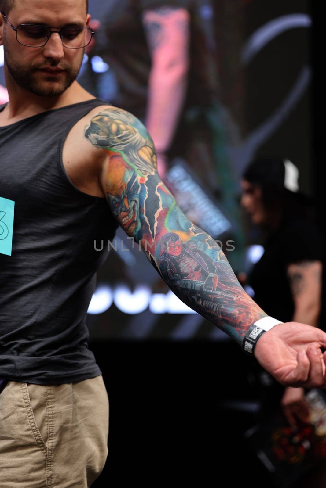 Krakow, Poland - June 12, 2022: Unidentified participant during the contest for the best tattoo at the 15th Tattoofest Convention in Cracow. One of the most prestigious tattoo festivals.
