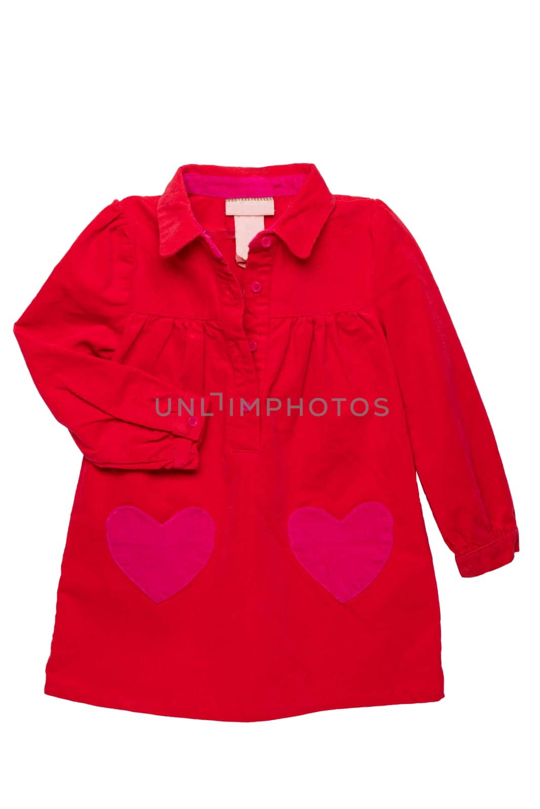 Summer dress isolated. A beautiful red girl's dress with attached heart shaped pockets and long sleeves isolated on white. Kids spring and autumn fashion.