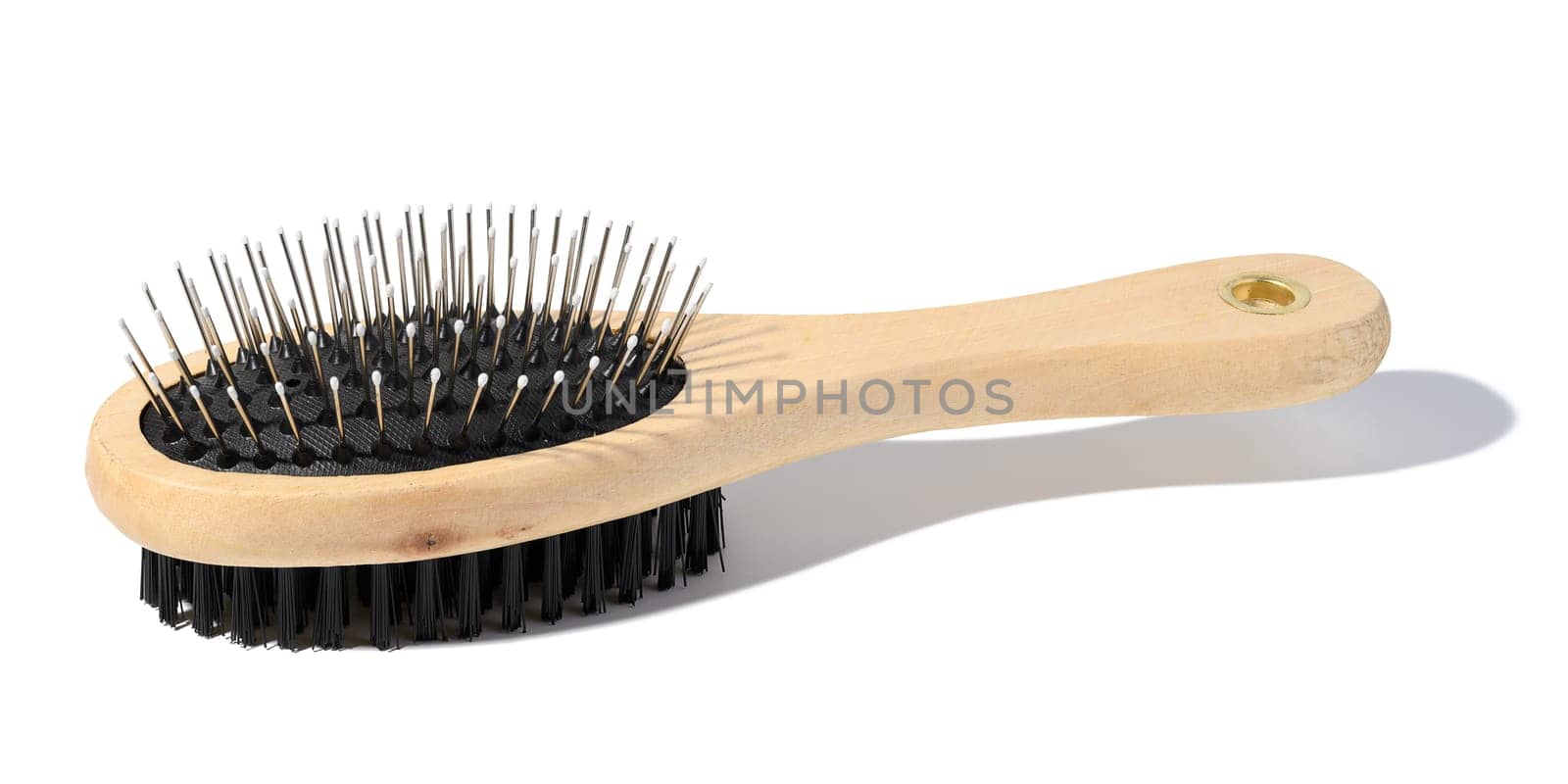 Wooden brush for animals on a white isolated background