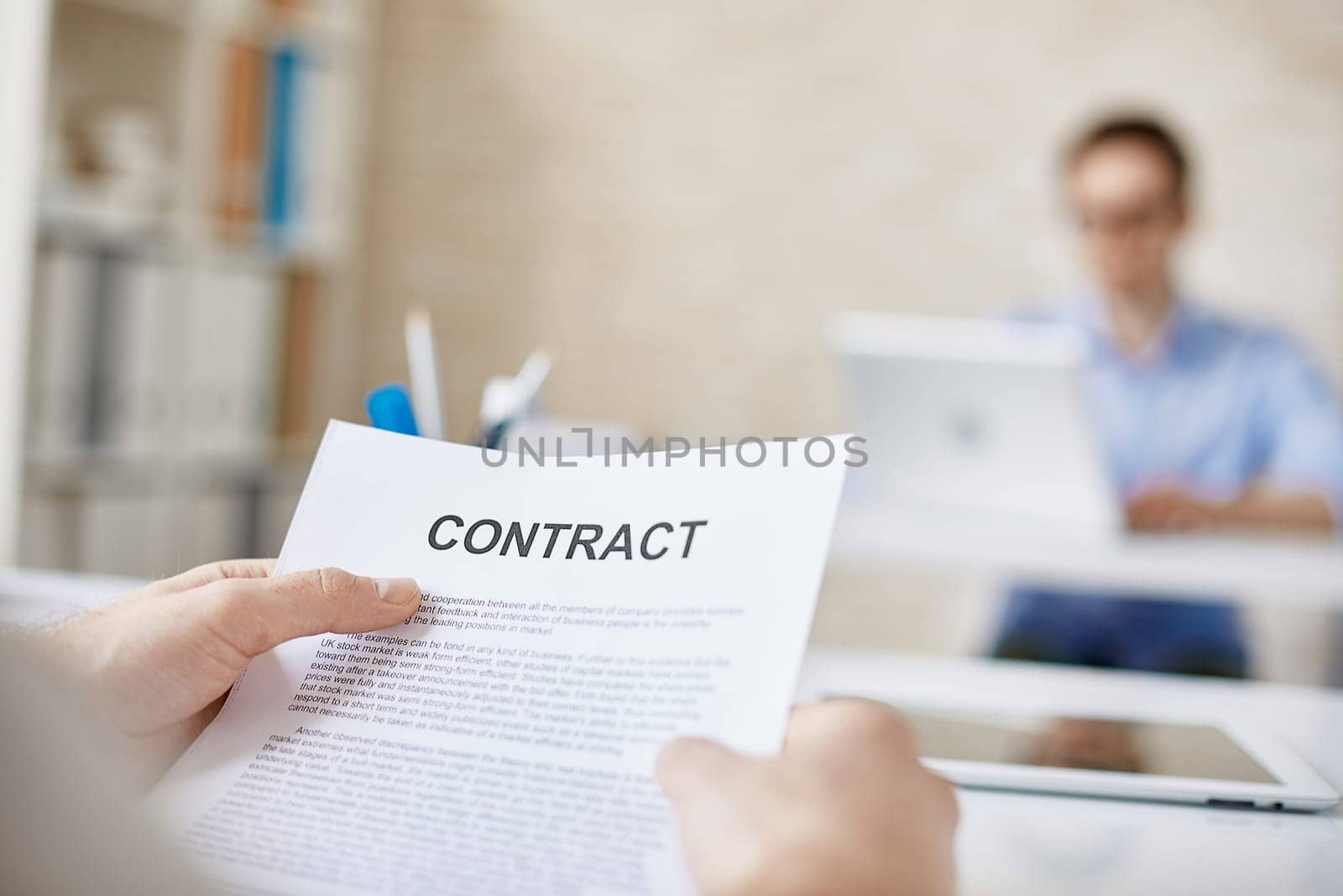 Contract in businessman hands in working environment