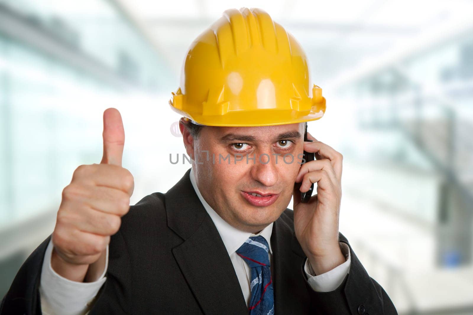 An engineer with yellow hat going thumbs up