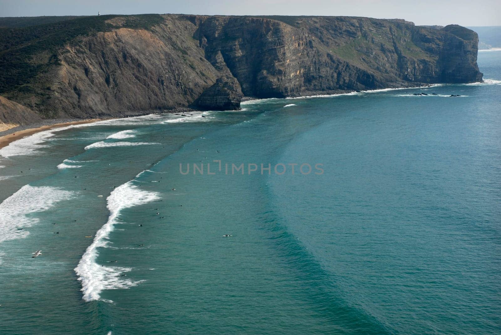 Beach, surfers from above, in the south of portugal