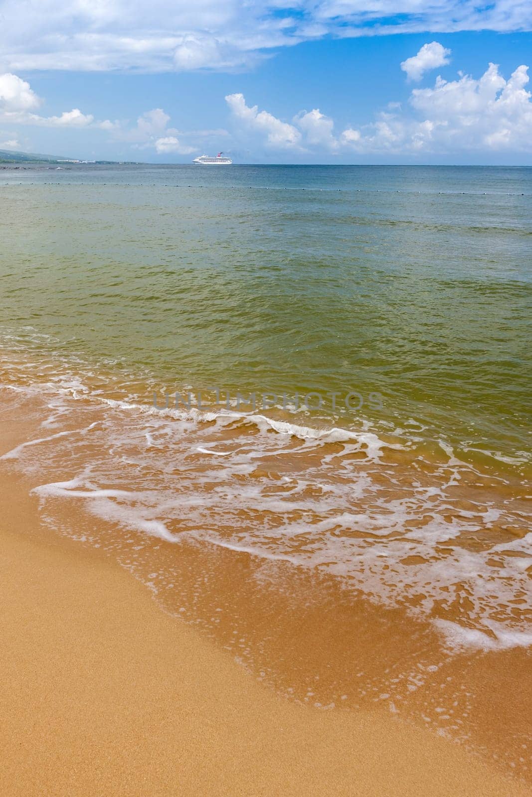 Beach on the tropical island. Clear blue water, sand and clouds. Beautiful vacation spot.